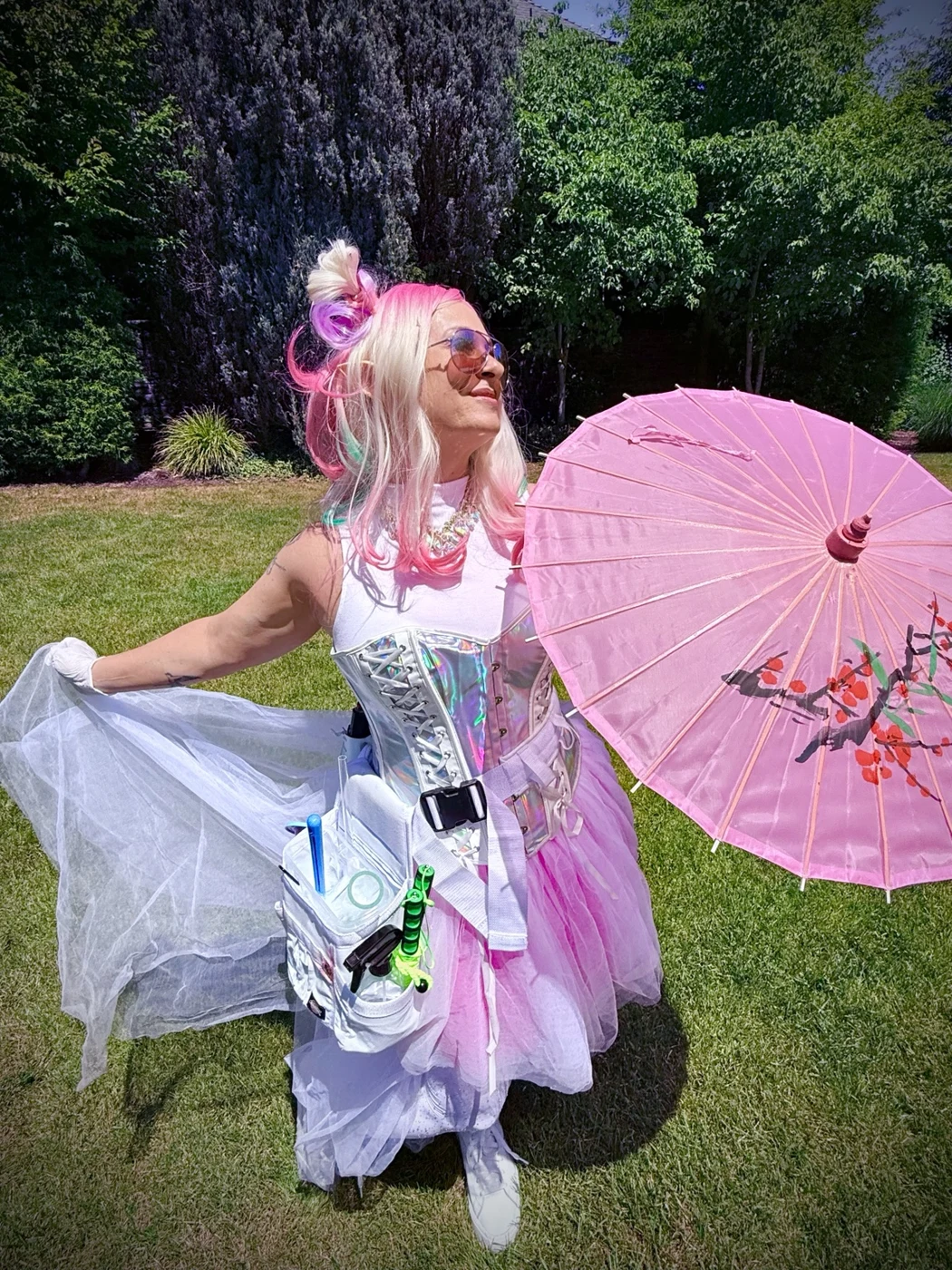 Bella in a fairy costume with wings and a pink parasol