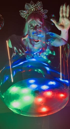Bella making bubbles over a colorful LED table
