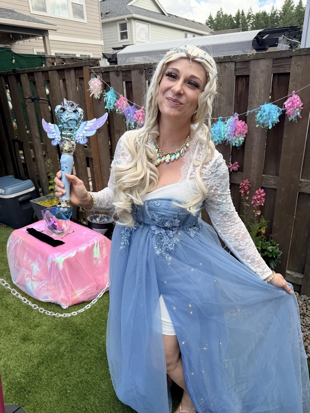 Bella wearing a blue princess costume at a garden party